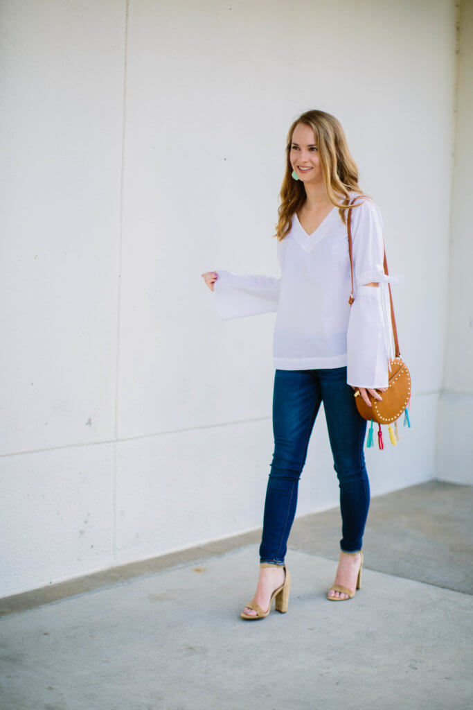 This white bell sleeve vee top is going to be on major repeat well into the summer. The material is super light and breathable, making it the perfect go-to top. I am absolutely in love with the fit, and how darling are the bow details on the sleeves!