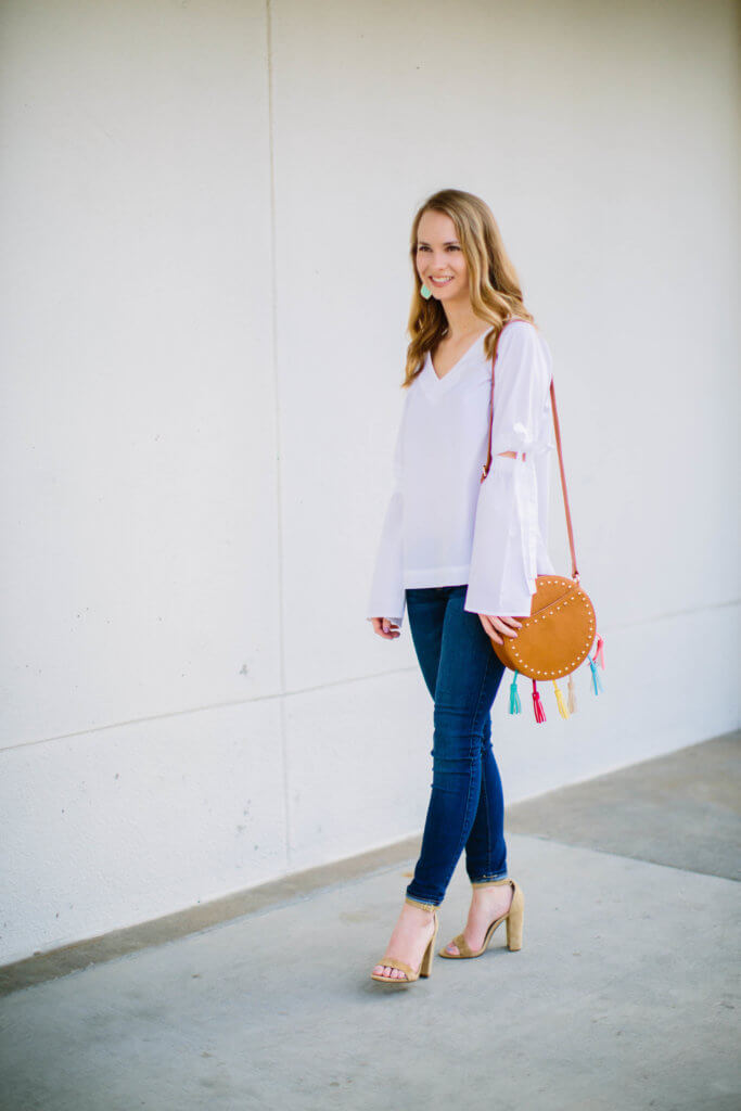 This white bell sleeve vee top is going to be on major repeat well into the summer. The material is super light and breathable, making it the perfect go-to top. I am absolutely in love with the fit, and how darling are the bow details on the sleeves!